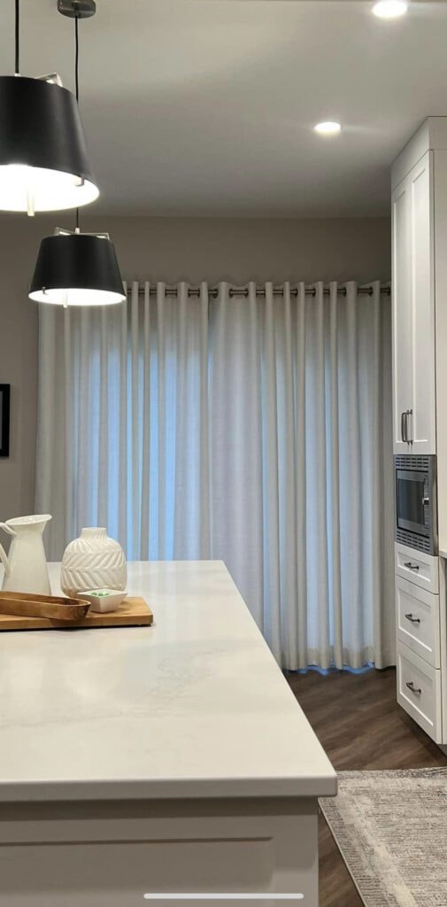 White sheer grommet curtains in modern kitchen
