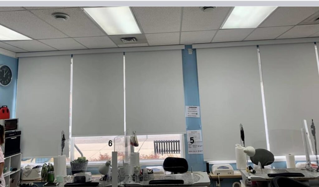 Grey roller blinds installed in commercial office space
