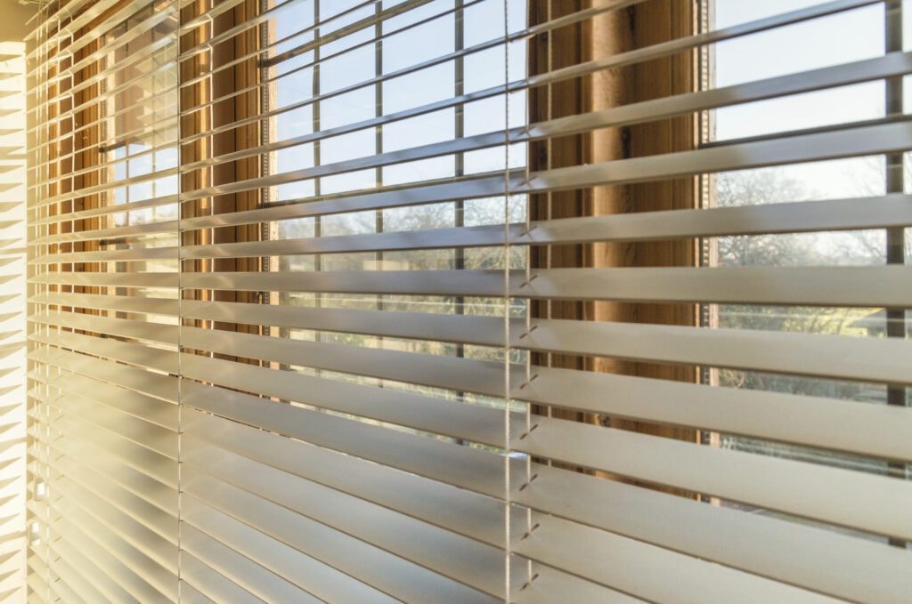 Close-up of warm sunlight filtering through venetian blinds