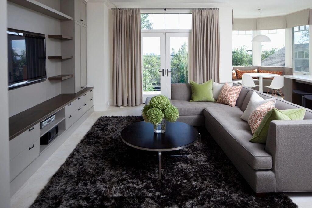 Modern living room with linen pinch pleat drapes and sectional sofa